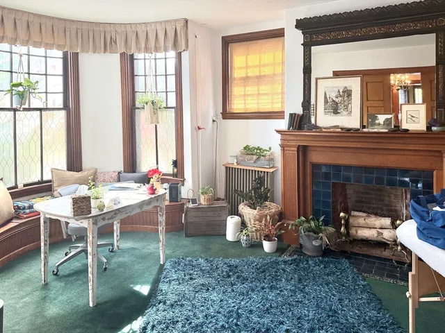 a living room with furniture and a fireplace
