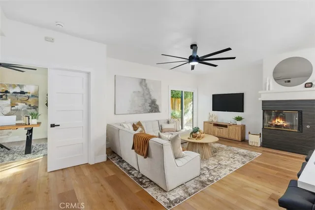 a living room with furniture fireplace and a flat screen tv