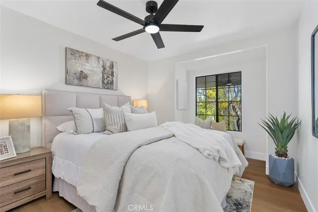a bedroom with a bed and a potted plant