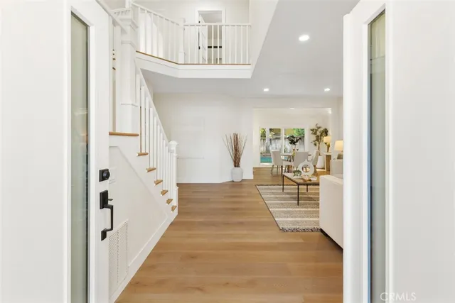 a view of entryway and hall with wooden floor