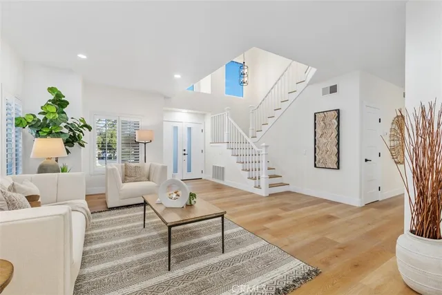 a living room with furniture and a potted plant