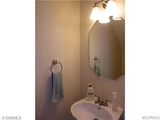 913 Biggin Pond Road Midlothian, VA 23114 - Photo 14 of 24 a bathroom with a sink and mirror