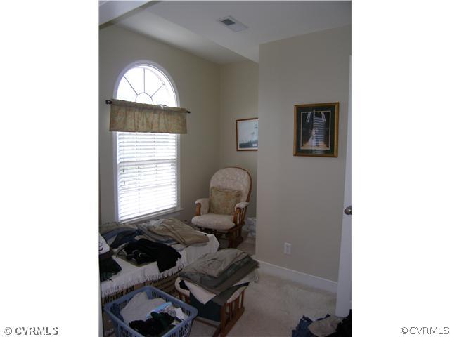 913 Biggin Pond Road Midlothian, VA 23114 - Photo 17 of 24 a living room with furniture and a window