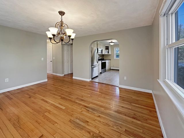 a kitchen with granite countertop a refrigerator stove top oven and sink