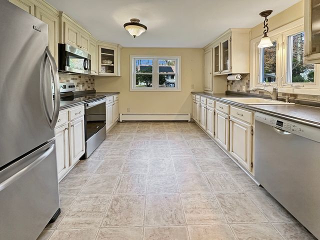 a kitchen with stainless steel appliances granite countertop a sink and cabinets