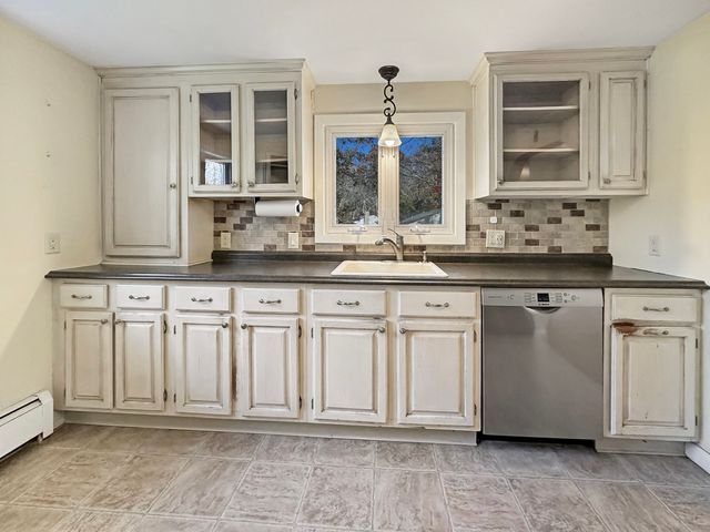 a kitchen with stainless steel appliances white cabinets white stove a microwave and a refrigerator