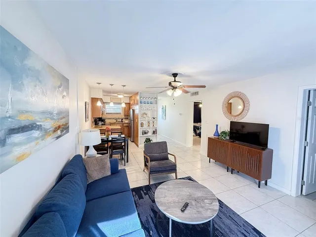 a kitchen with stainless steel appliances kitchen island granite countertop a refrigerator and a stove