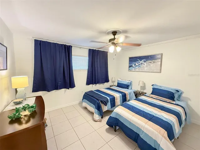 a bedroom with two beds and a chandelier