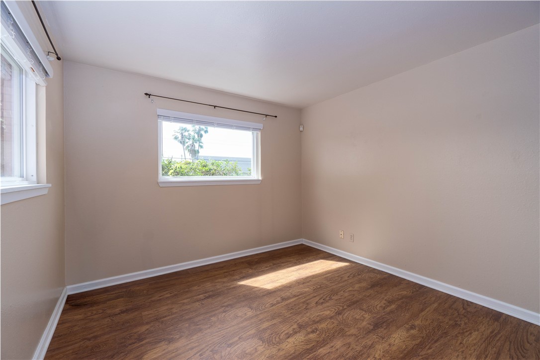 6232 Weber Road Corpus Christi, TX 78413 - Photo 13 of 23 an empty room with wooden floor and windows