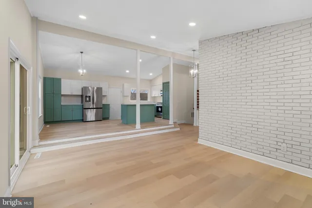 a view of kitchen with refrigerator and window