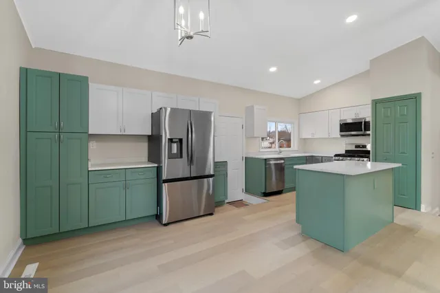 a kitchen with a sink and a stove top oven