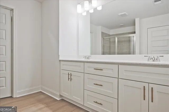 a bathroom with a sink and vanity