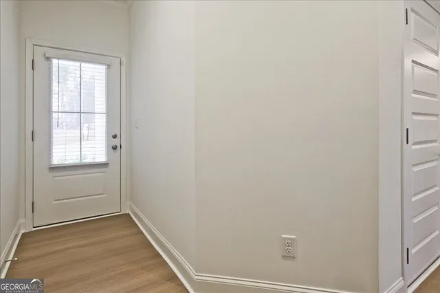 a view of a small space with wooden floor and windows