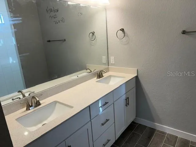 a bathroom with a sink vanity and a mirror