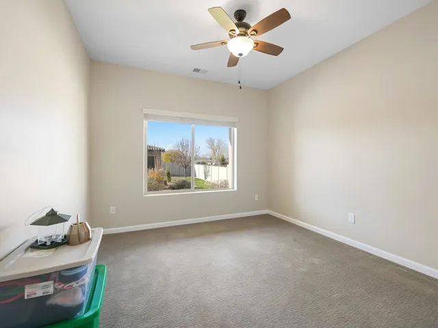 a view of room with window and ceiling fan