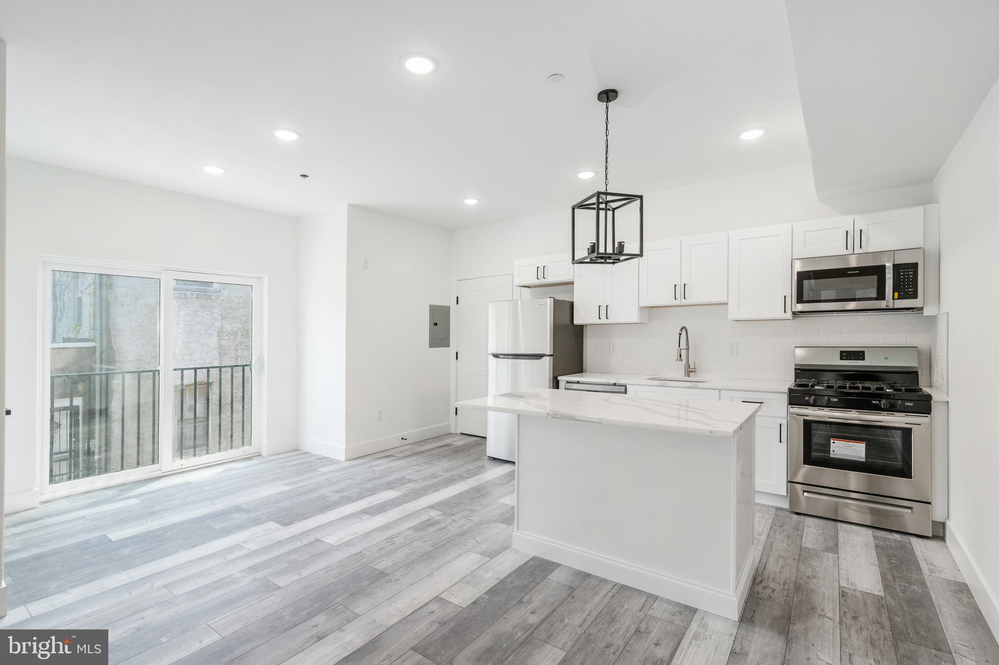 4111 Parrish Street Philadelphia, PA 19104 - Photo 18 of 38 a kitchen with white cabinets and stainless steel appliances