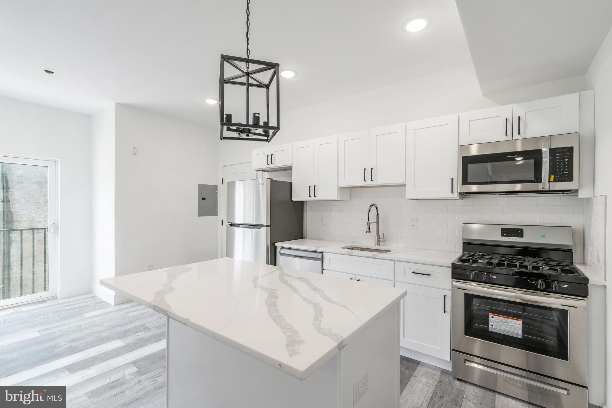 4111 Parrish Street Philadelphia, PA 19104 - Photo 19 of 38 a kitchen with stainless steel appliances a stove sink microwave and cabinets