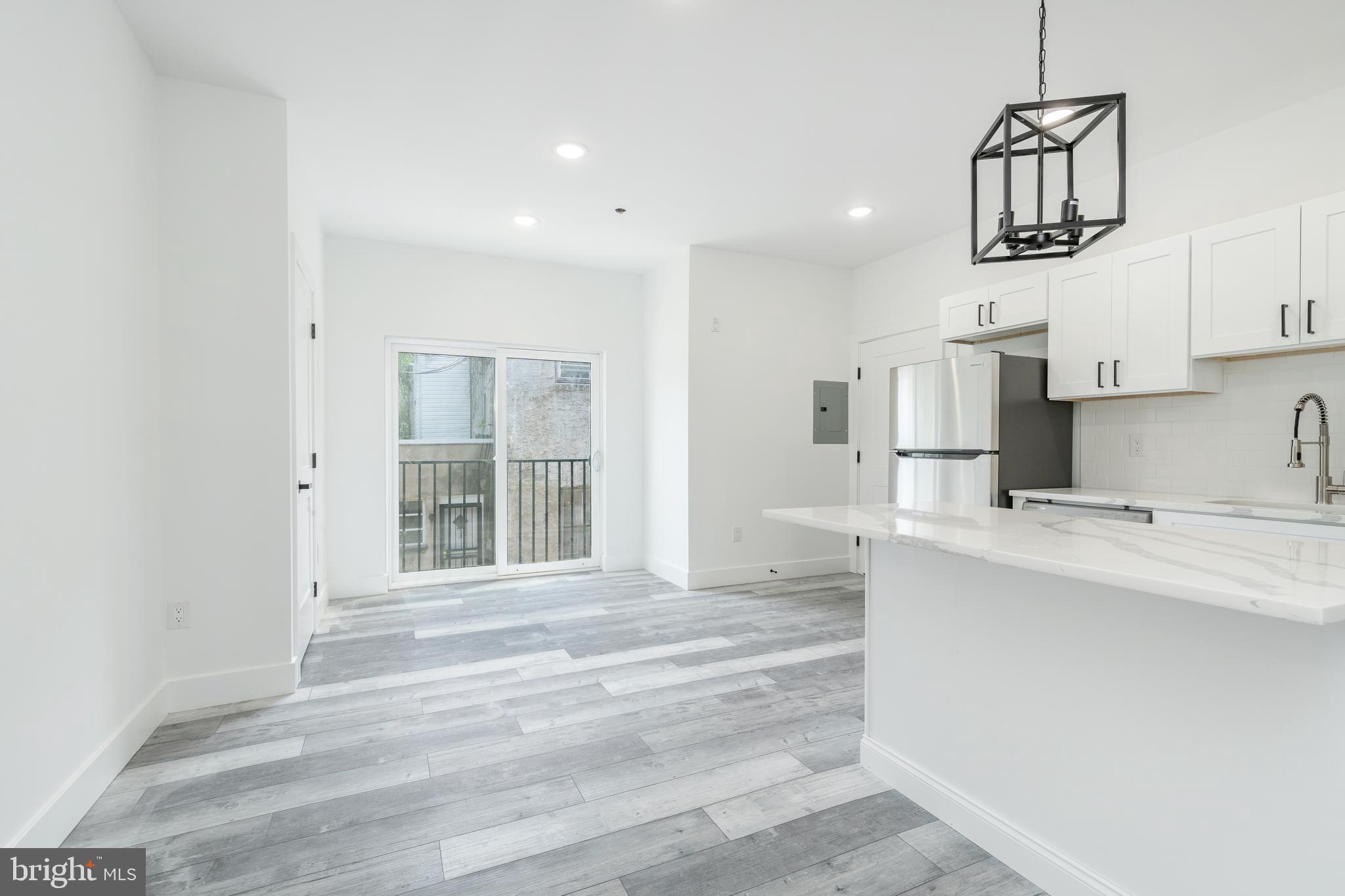 4111 Parrish Street Philadelphia, PA 19104 - Photo 21 of 38 a kitchen with stainless steel appliances a sink stove and cabinets