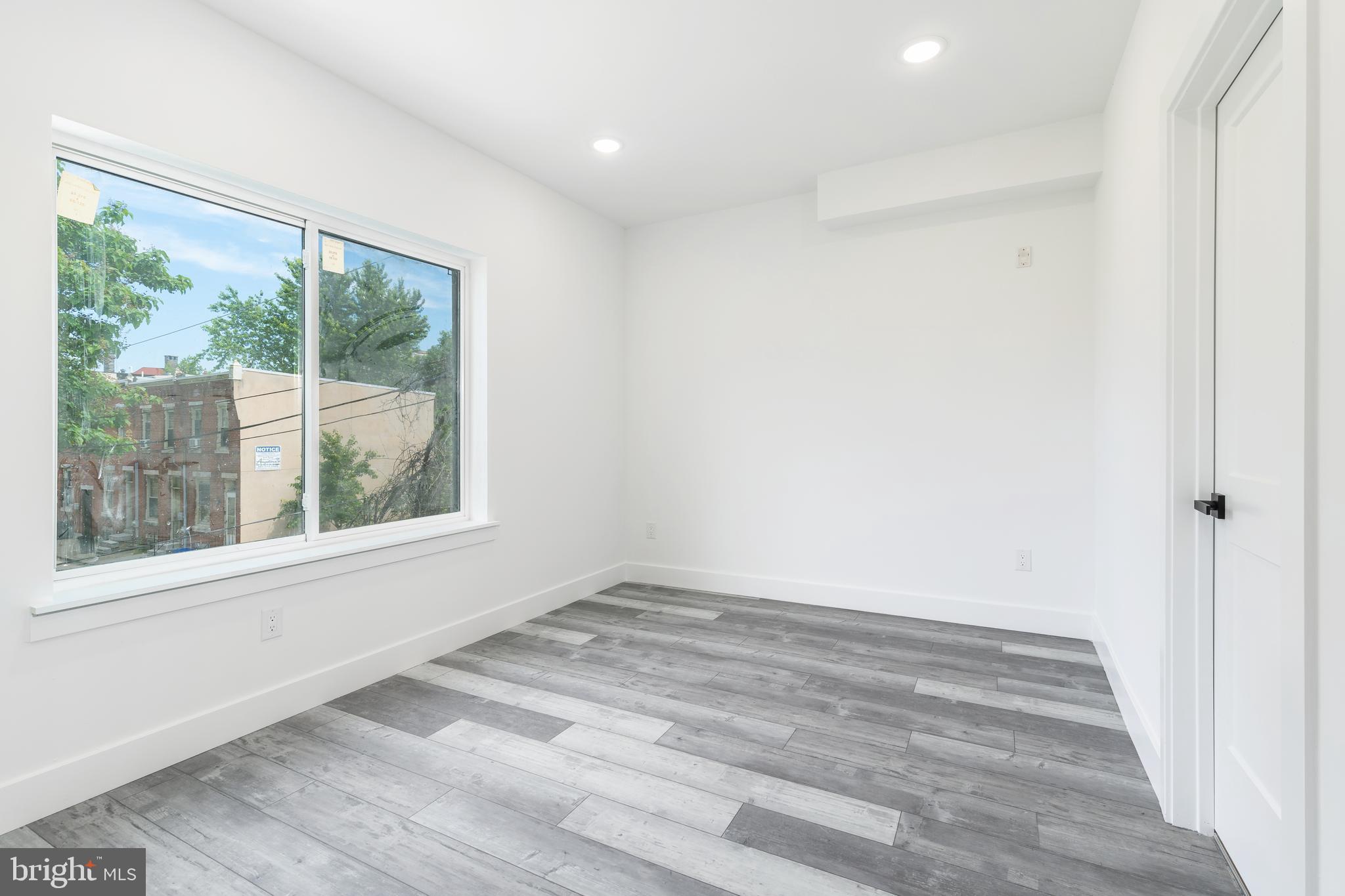 4111 Parrish Street Philadelphia, PA 19104 - Photo 22 of 38 a view of an empty room with wooden floor and a window