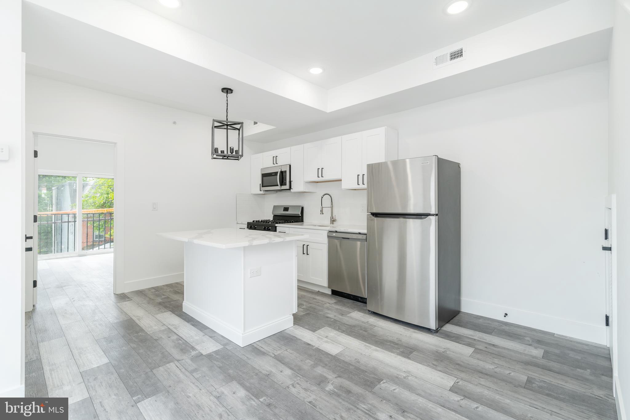 4111 Parrish Street Philadelphia, PA 19104 - Photo 26 of 38 a kitchen with refrigerator cabinets and wooden floor