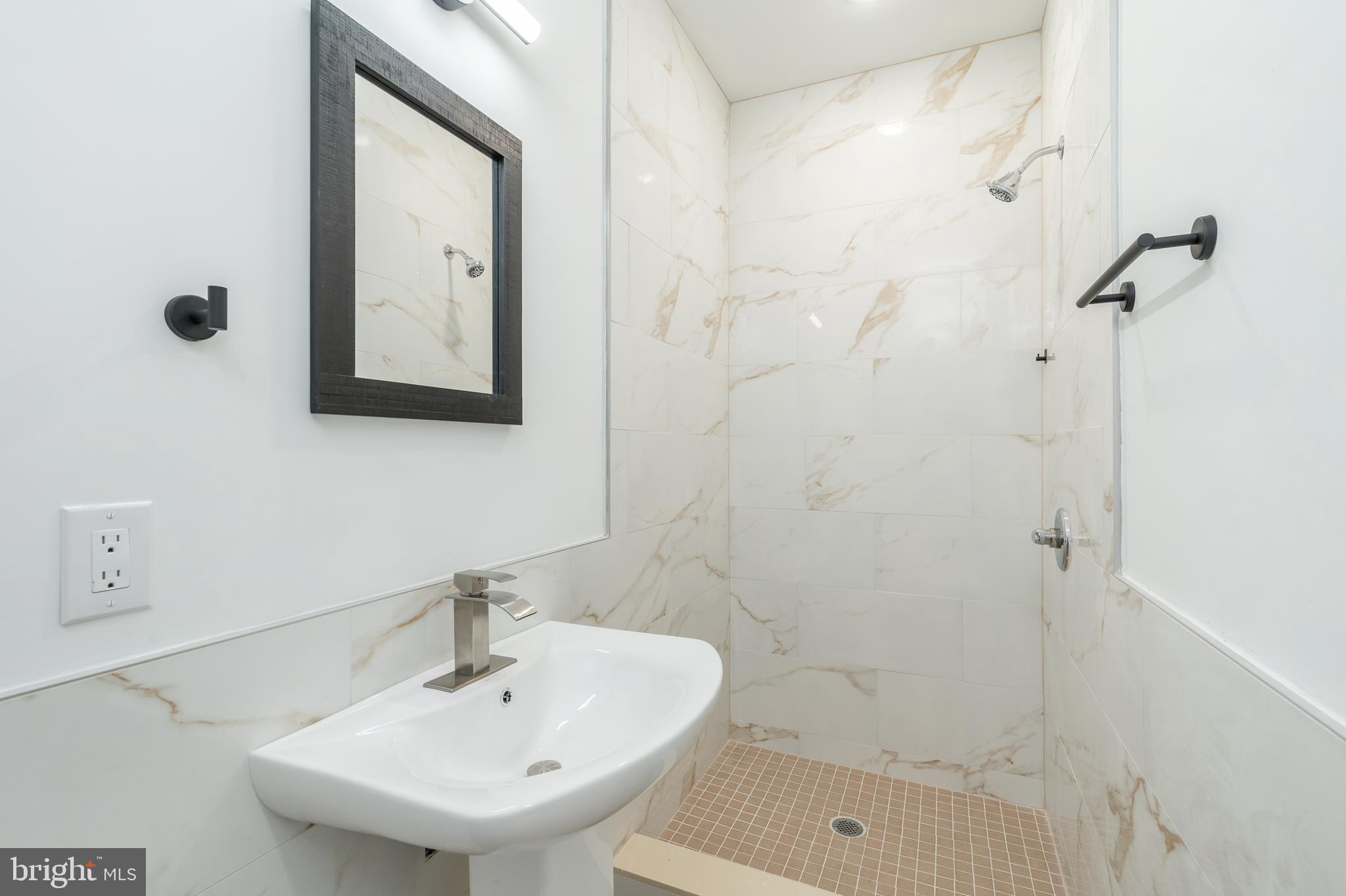 4111 Parrish Street Philadelphia, PA 19104 - Photo 30 of 38 a bathroom with a sink a shower and a mirror