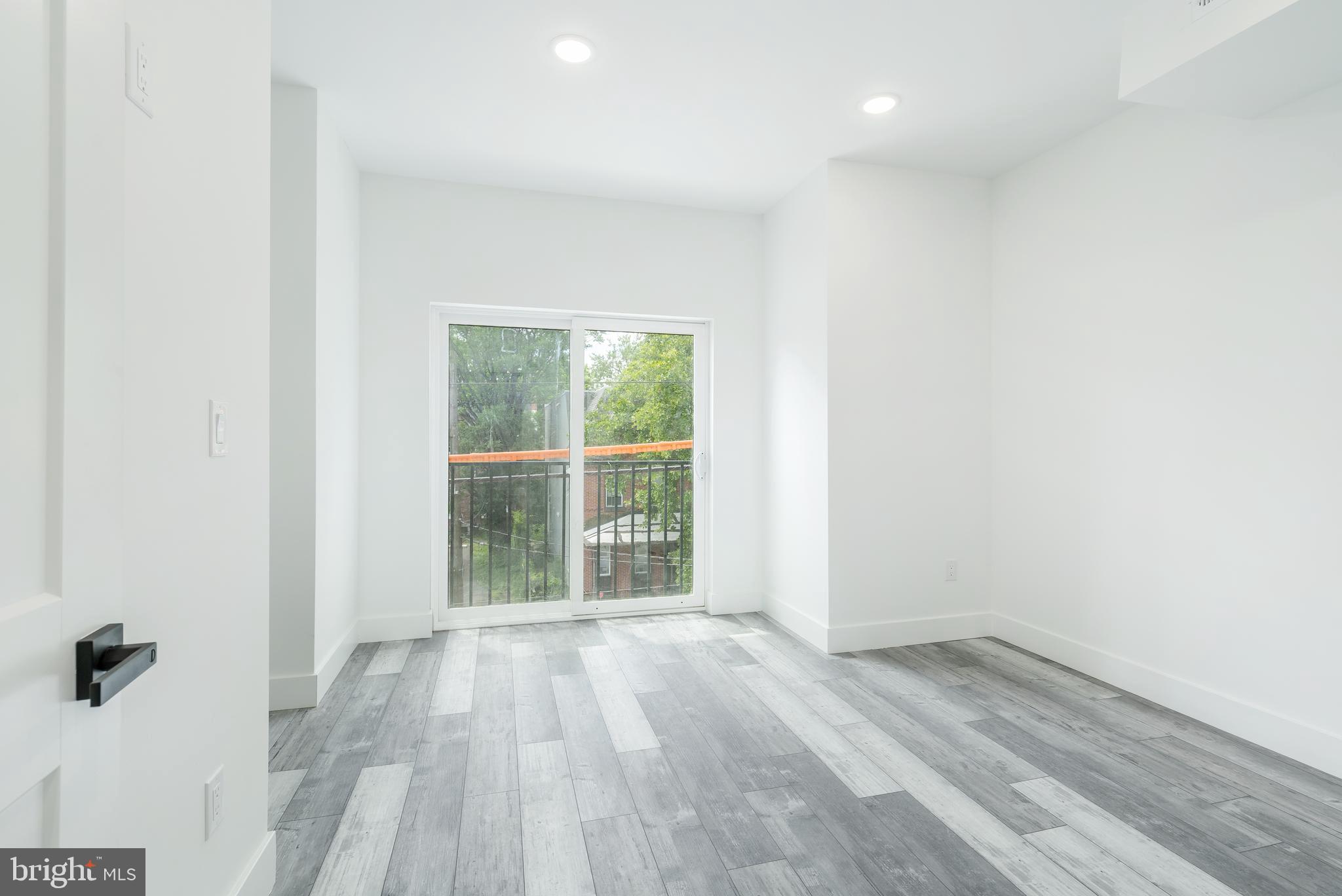 4111 Parrish Street Philadelphia, PA 19104 - Photo 31 of 38 an empty room with wooden floor and windows