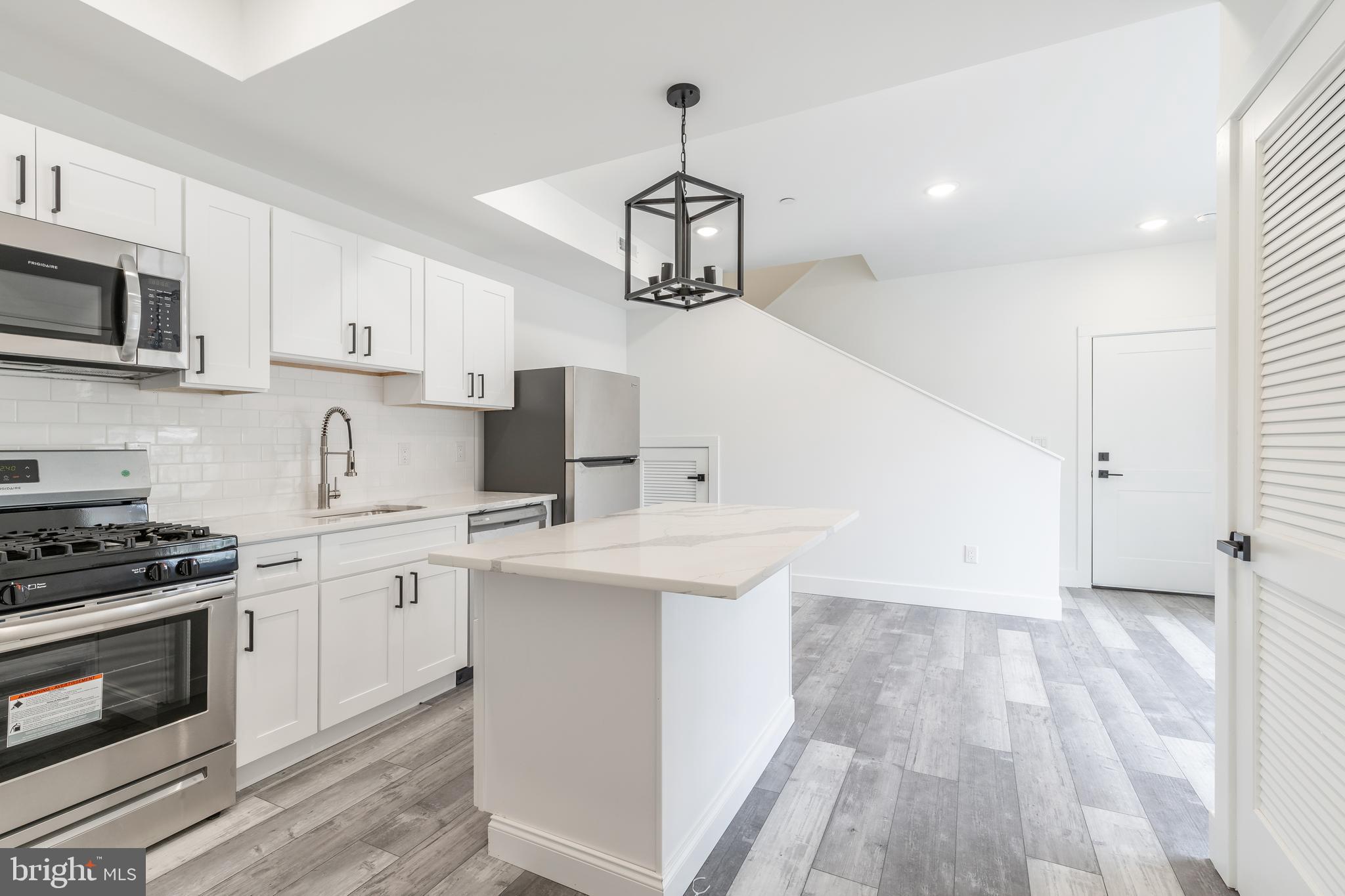 4111 Parrish Street Philadelphia, PA 19104 - Photo 33 of 38 a kitchen with stainless steel appliances a stove a sink and white cabinets