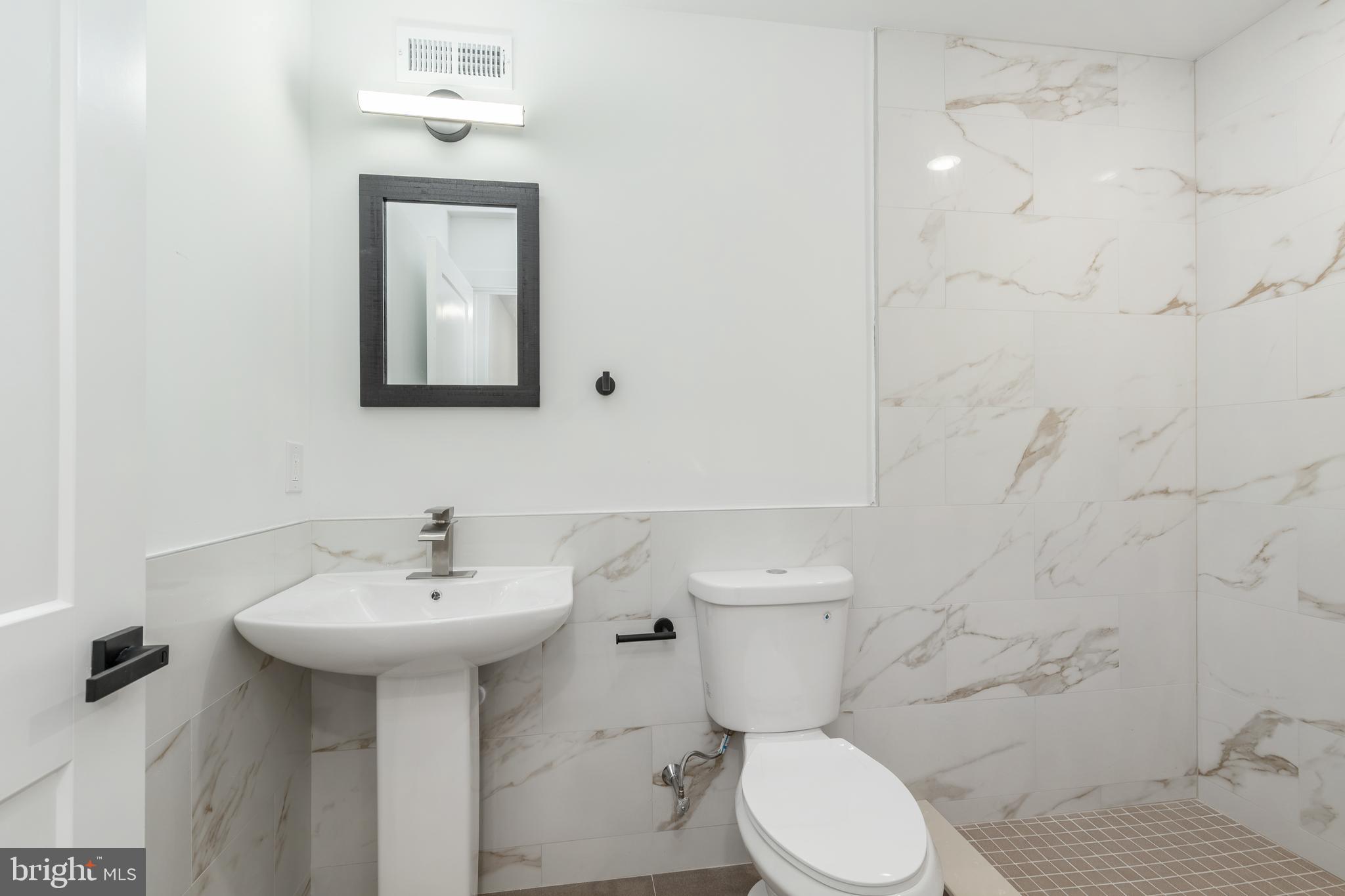 4111 Parrish Street Philadelphia, PA 19104 - Photo 35 of 38 a bathroom with a sink toilet and mirror