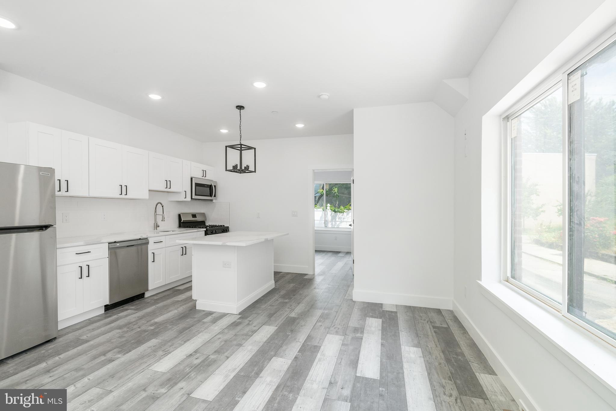 4111 Parrish Street Philadelphia, PA 19104 - Photo 4 of 38 a kitchen with white cabinets and white appliances