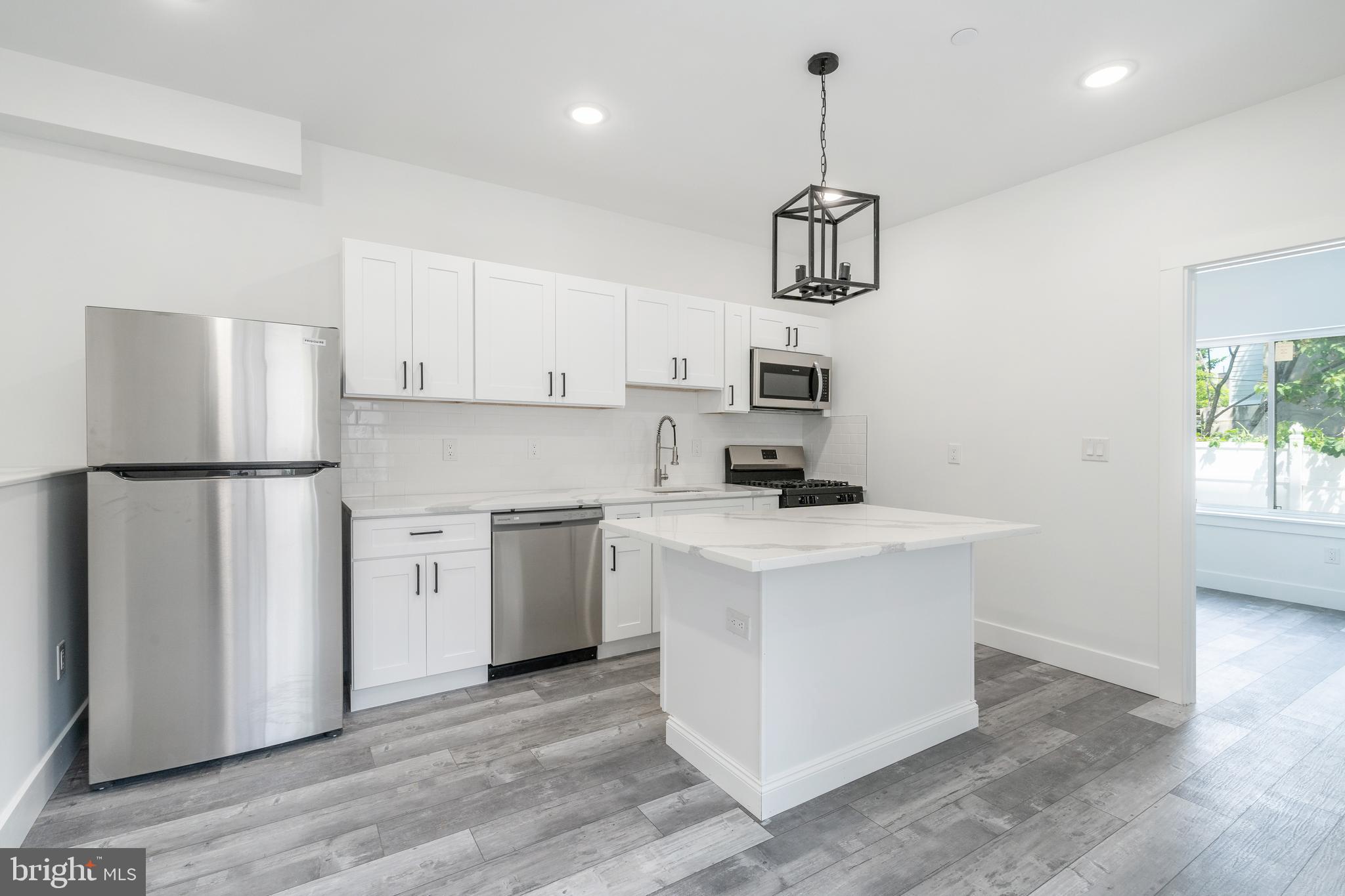 4111 Parrish Street Philadelphia, PA 19104 - Photo 5 of 38 a kitchen with a refrigerator a stove cabinets and wooden floor