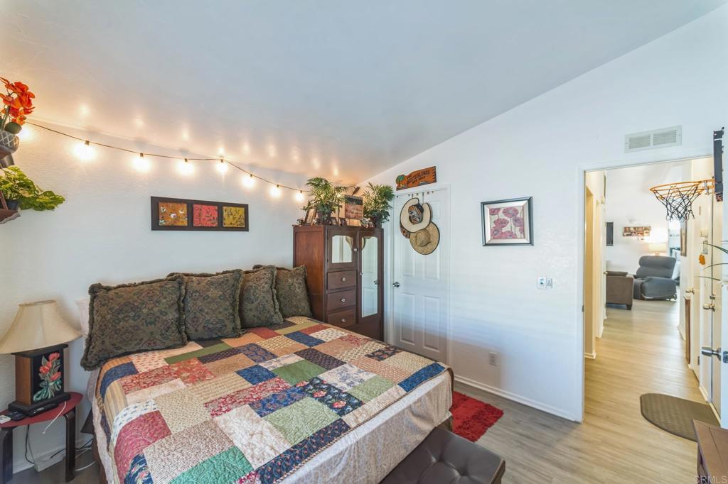 27250 Murrieta Road, Unit 364 Menifee, CA 92586 - Photo 13 of 17 a bedroom with a bed and wooden floor