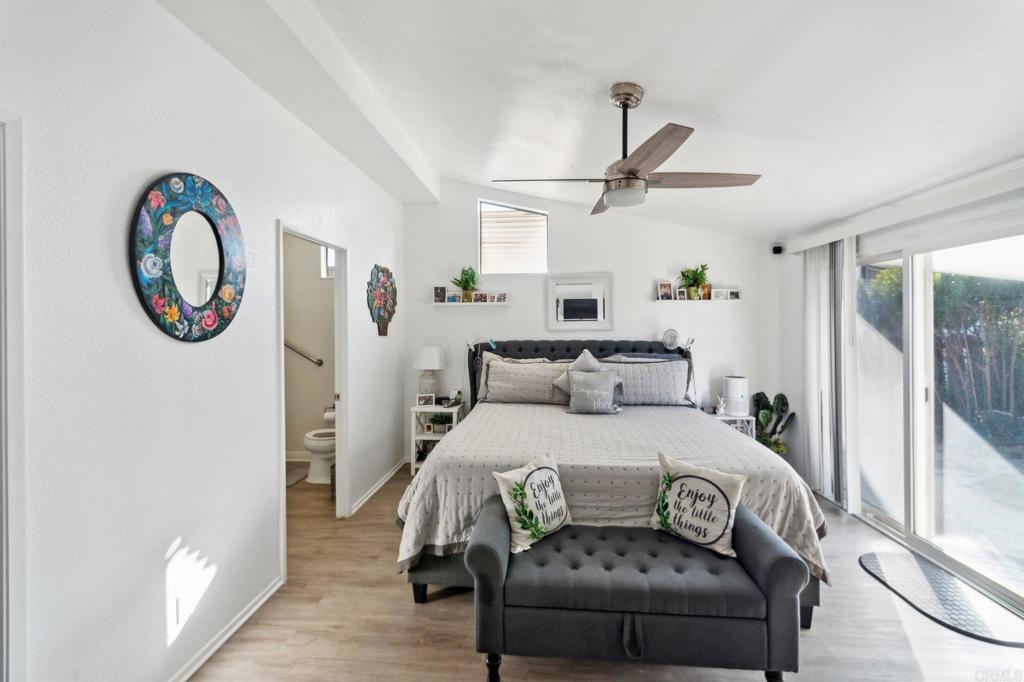 27250 Murrieta Road, Unit 364 Menifee, CA 92586 - Photo 14 of 17 a bedroom with a bed and a chandelier