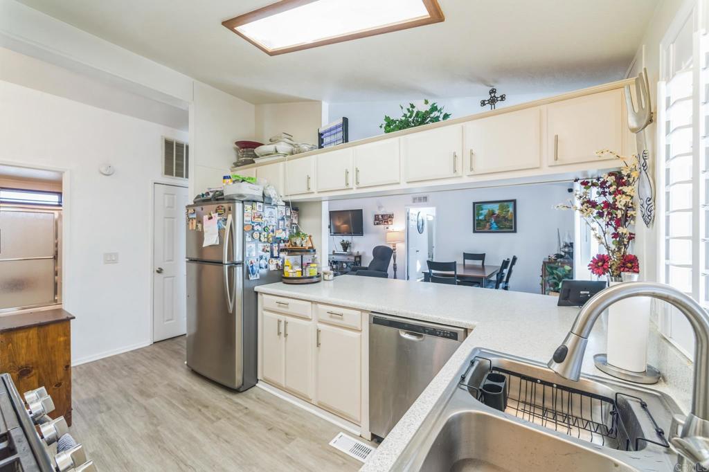 27250 Murrieta Road, Unit 364 Menifee, CA 92586 - Photo 3 of 17 a kitchen with stainless steel appliances granite countertop a refrigerator and a sink