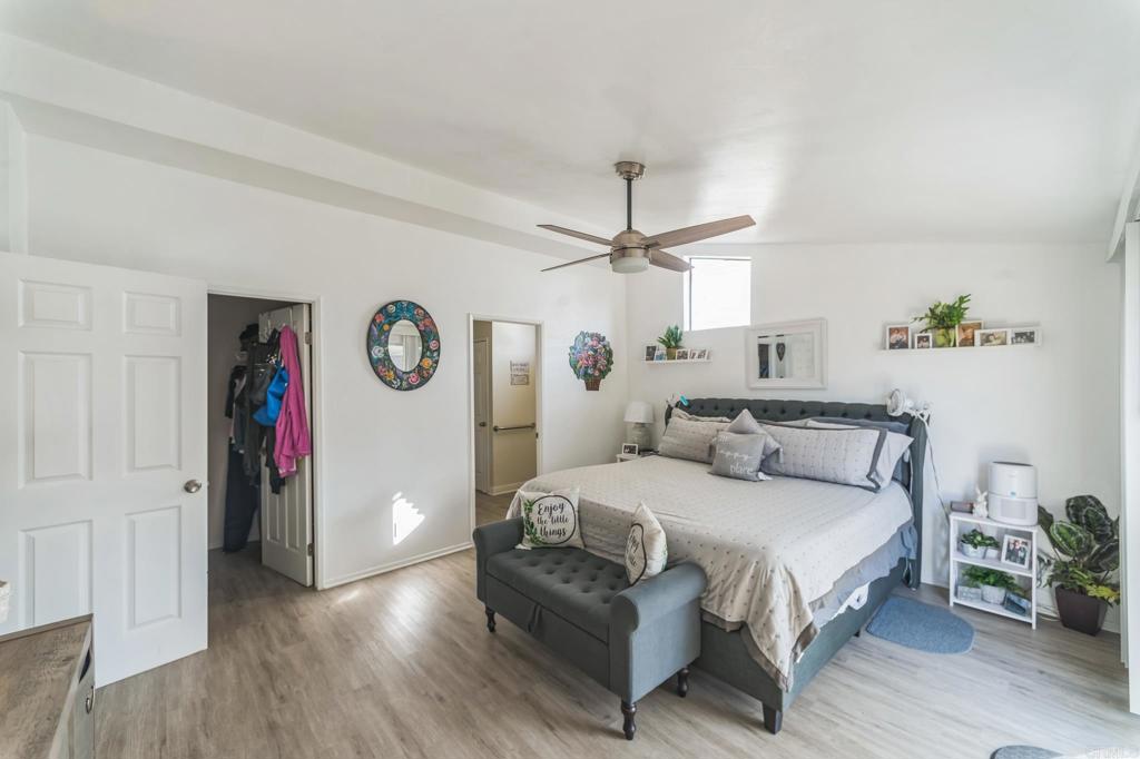 27250 Murrieta Road, Unit 364 Menifee, CA 92586 - Photo 10 of 17 a bedroom with a bed and a chandelier