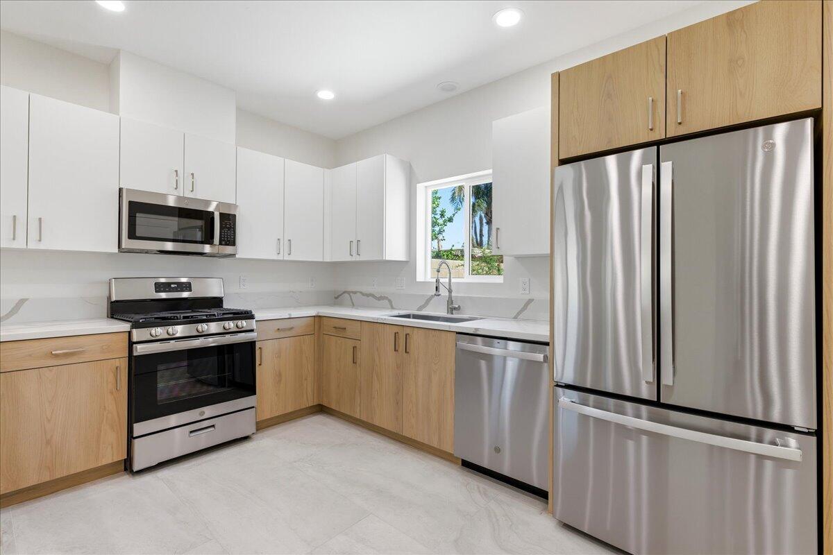 68160 Modalo Road Cathedral City, CA 92234 - Photo 14 of 57 a kitchen with stainless steel appliances a refrigerator sink and microwave
