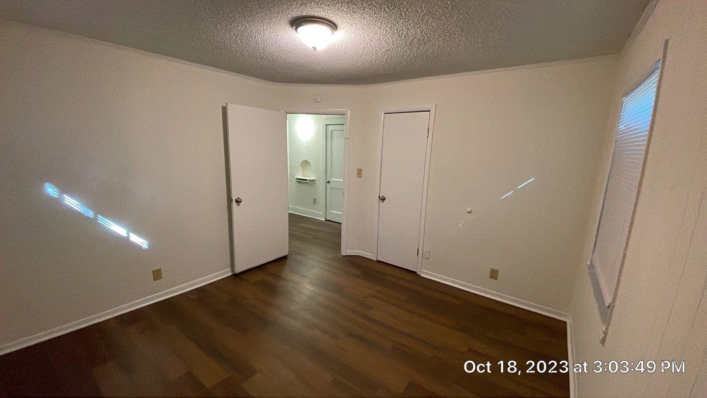 75 East Peebles Road Memphis, TN 38109 - Photo 4 of 10 an empty room with wooden floor and windows