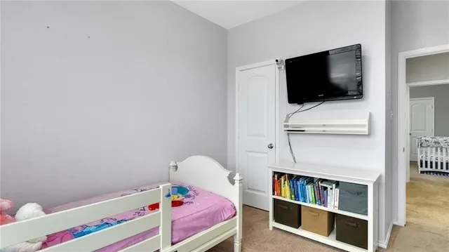 a room with a bed and television