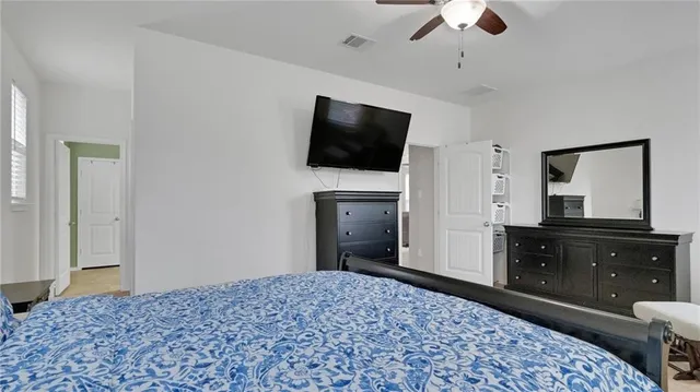 a bedroom with a bed and a television in it