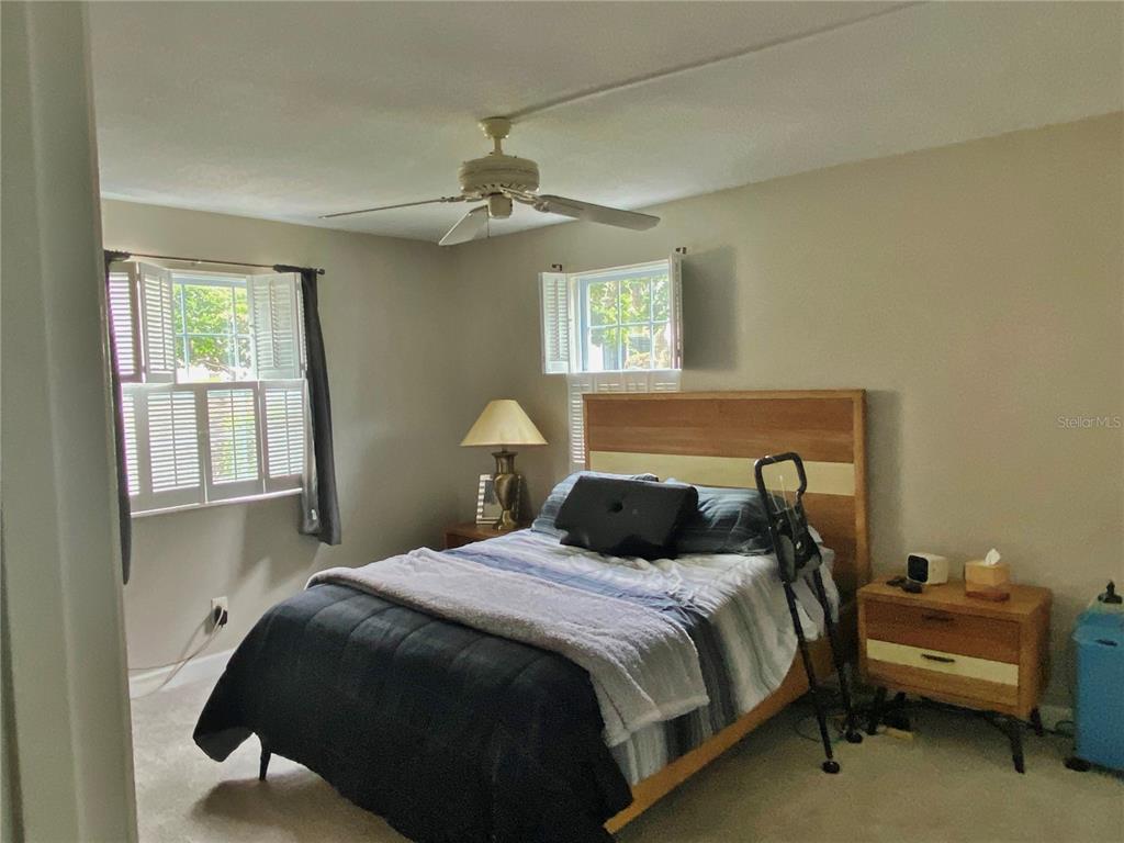 1500 Gay Road, Unit 24B Winter Park, FL 32789 - Photo 13 of 21 a bedroom with a bed and a chandelier