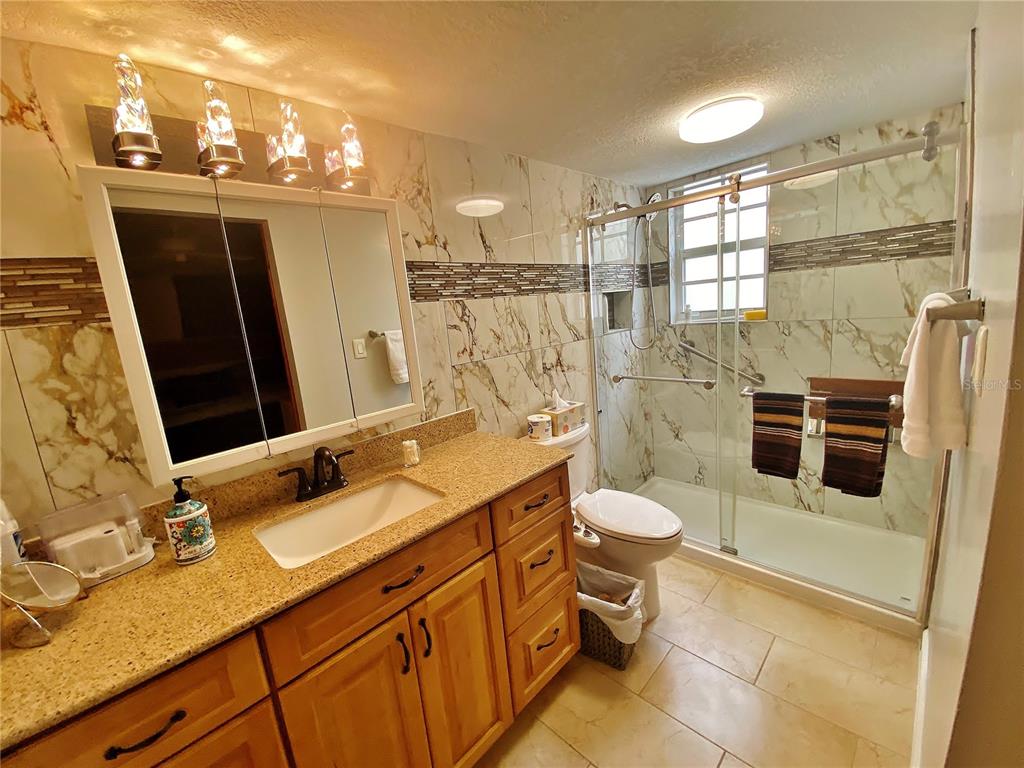 1500 Gay Road, Unit 24B Winter Park, FL 32789 - Photo 14 of 21 a bathroom with a sink a toilet and shower