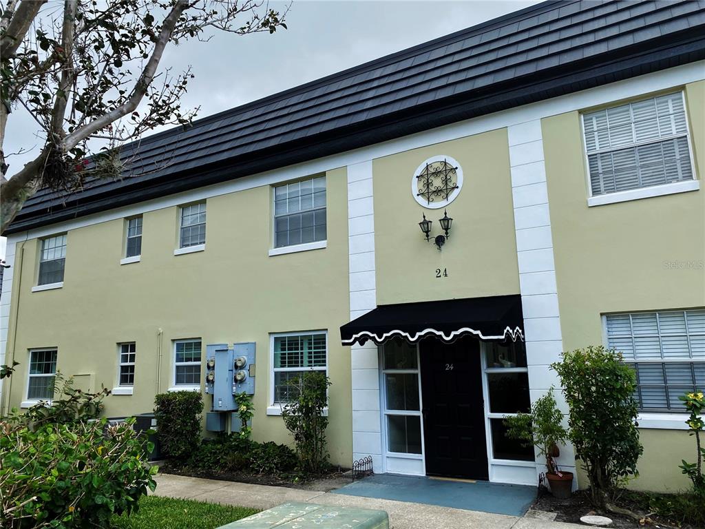 1500 Gay Road, Unit 24B Winter Park, FL 32789 - Photo 2 of 21 a front view of a house with a potted plant and a large window