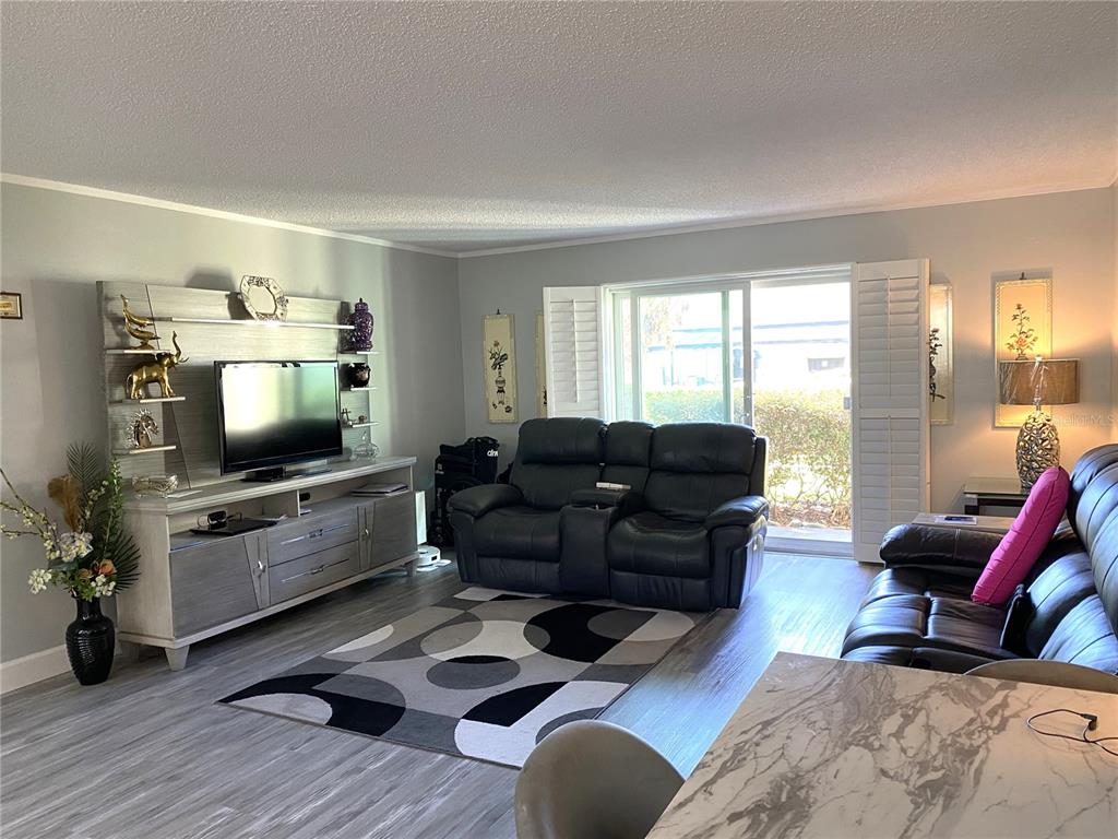 1500 Gay Road, Unit 24B Winter Park, FL 32789 - Photo 5 of 21 a living room with furniture and a flat screen tv