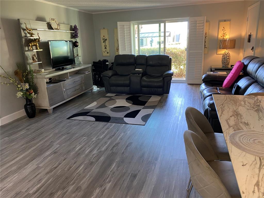 1500 Gay Road, Unit 24B Winter Park, FL 32789 - Photo 6 of 21 a living room with furniture and a flat screen tv