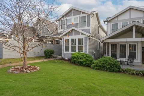 a front view of a house with a garden