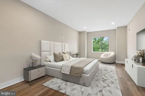 a bedroom with a bed and a couch