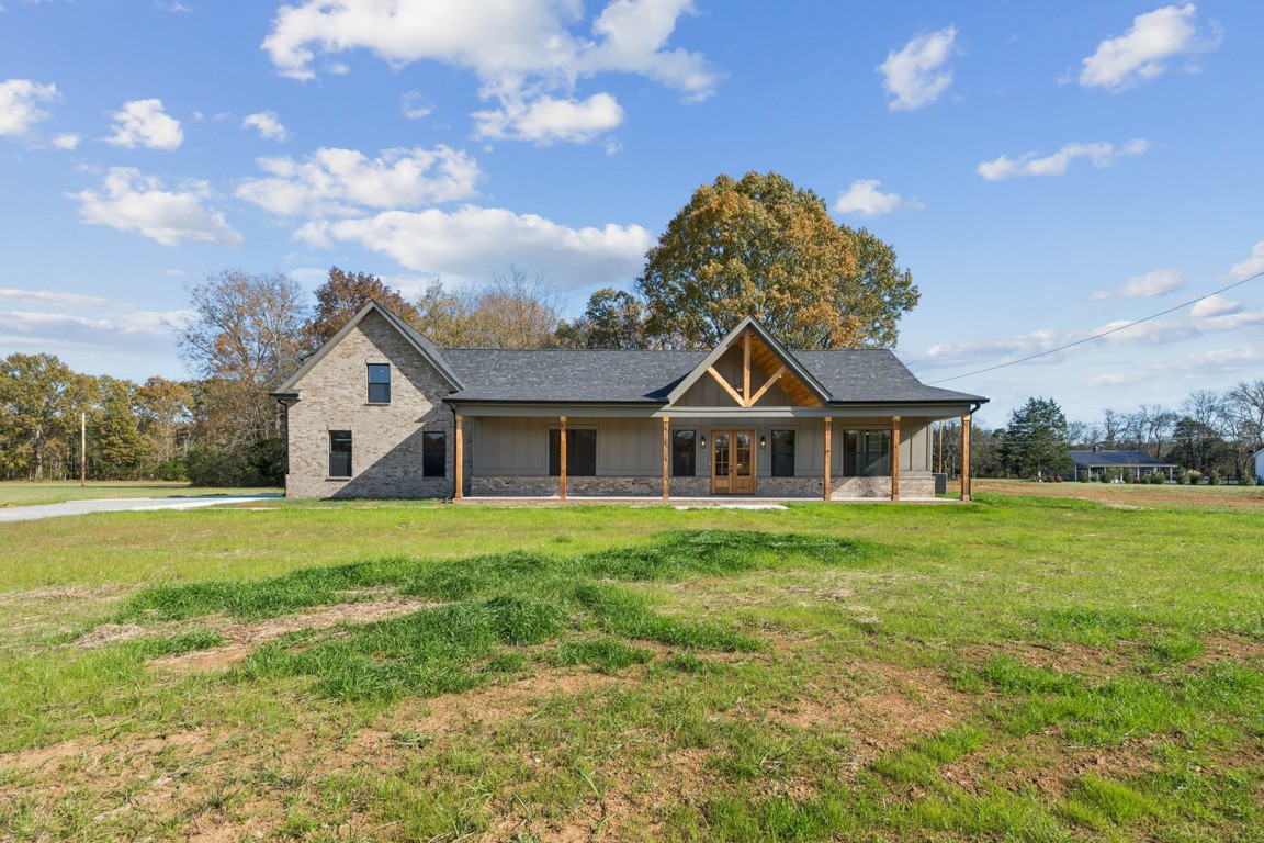 a front view of a house with a garden