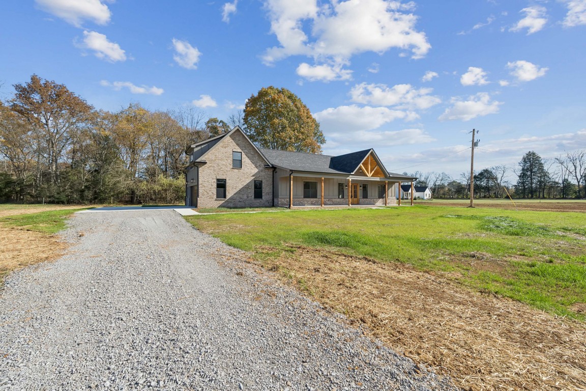 2309 Hunter Road Lewisburg, TN 37091 - Photo 4 of 27 a view of a house with a big yard and large trees