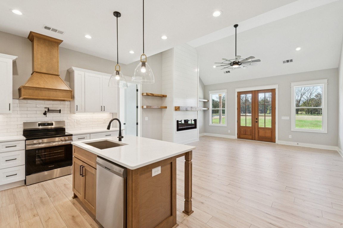 2309 Hunter Road Lewisburg, TN 37091 - Photo 8 of 27 a kitchen with a stove a sink a center island a refrigerator and a wooden floor