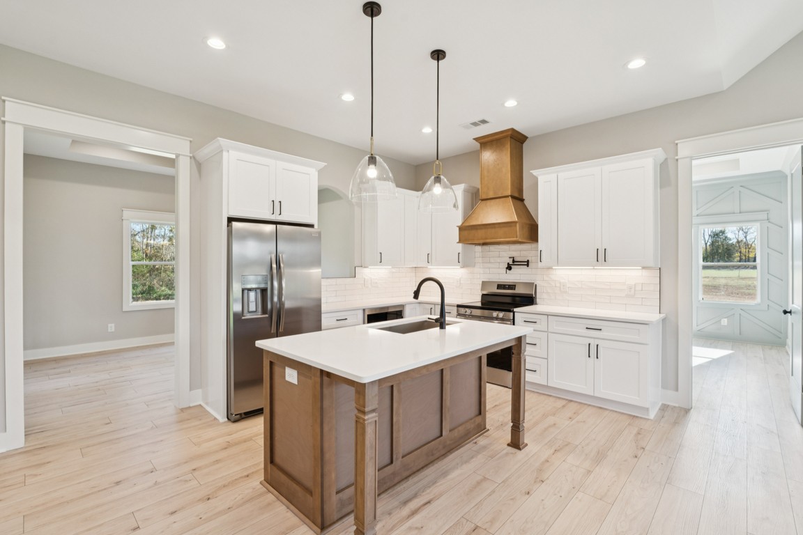 2309 Hunter Road Lewisburg, TN 37091 - Photo 10 of 27 a kitchen with white cabinets and stainless steel appliances
