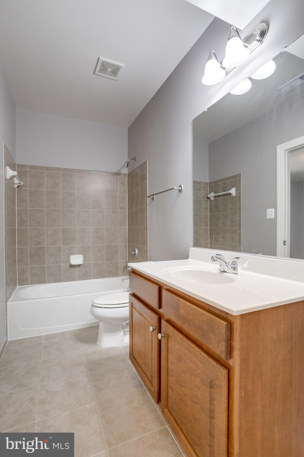 18475 Kerill Road Triangle, VA 22172 - Photo 38 of 99 a bathroom with a sink a toilet a mirror and bathtub